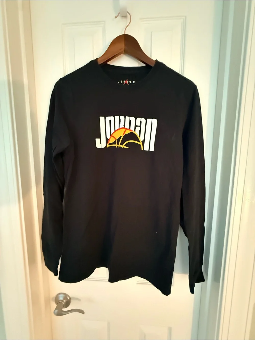 Jordan Black Long Sleeve Tee with White Logo and Orange Basketball Accent